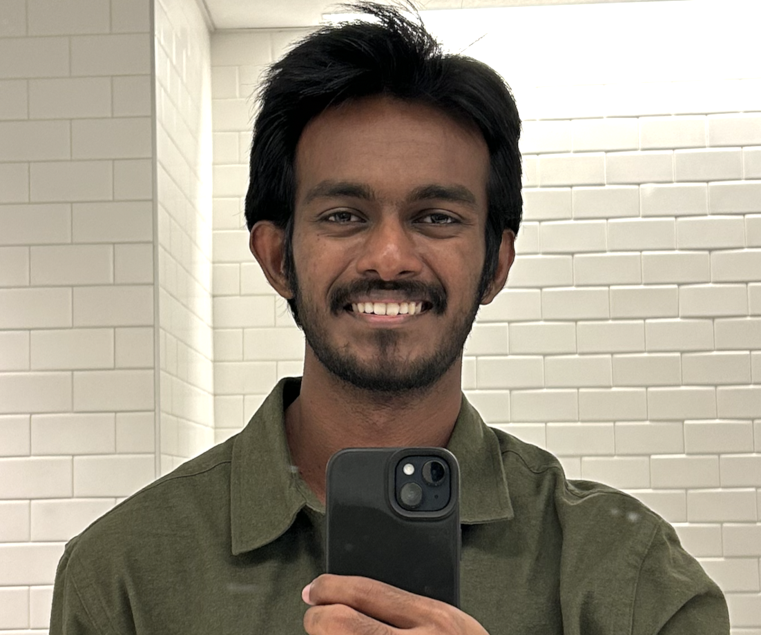 Sanjith smiling in a mirror selfie